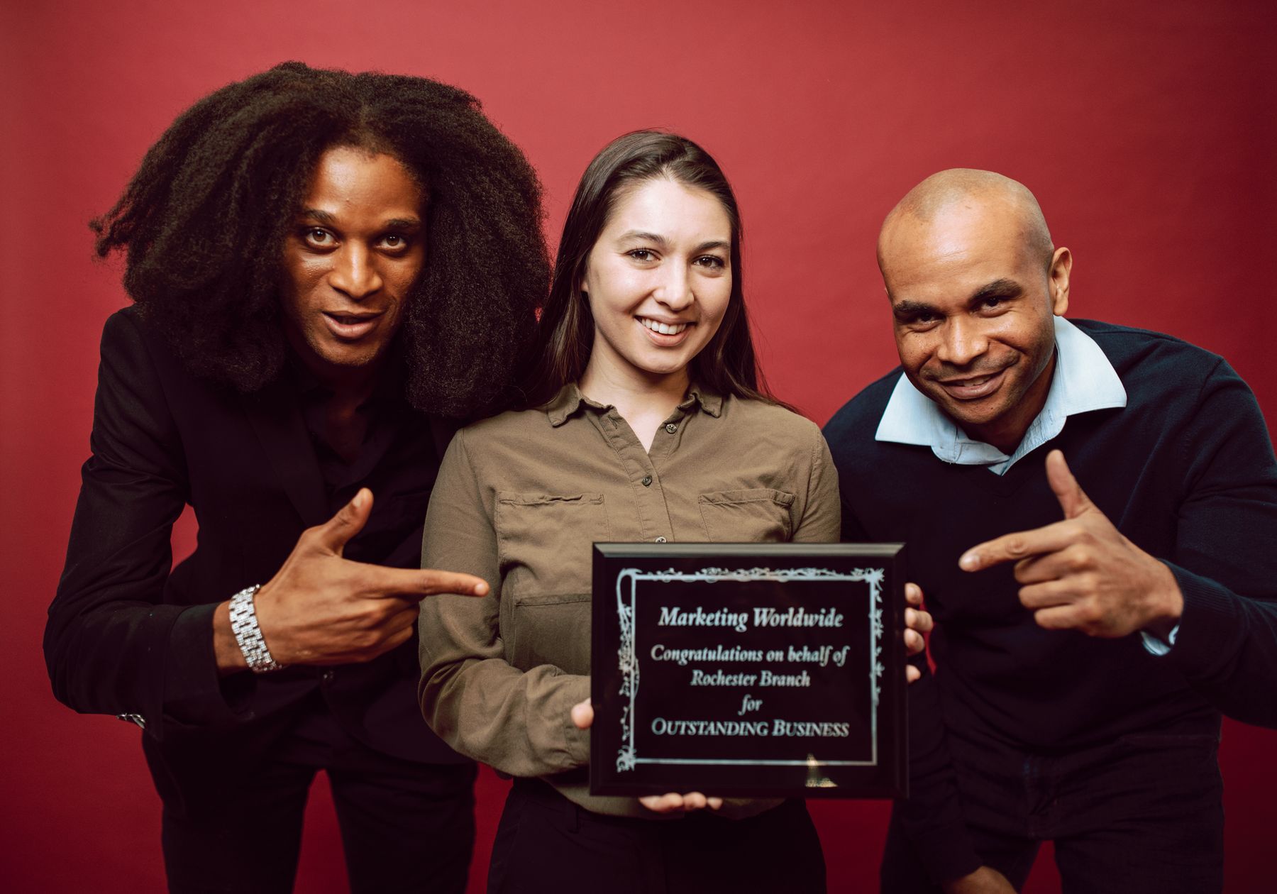 A professional team holding a recognition plaque