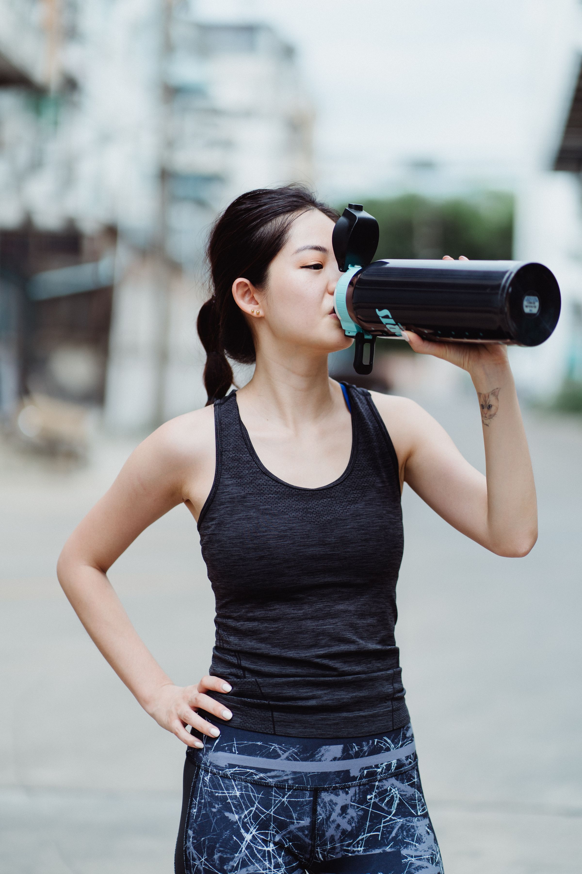 Woman drinking water after outdoor exercise